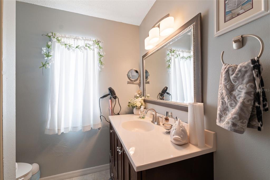 12265 Shafton Road Spring Hill, FL 34608 - Photo 50 of 51 a bathroom with a sink and a mirror
