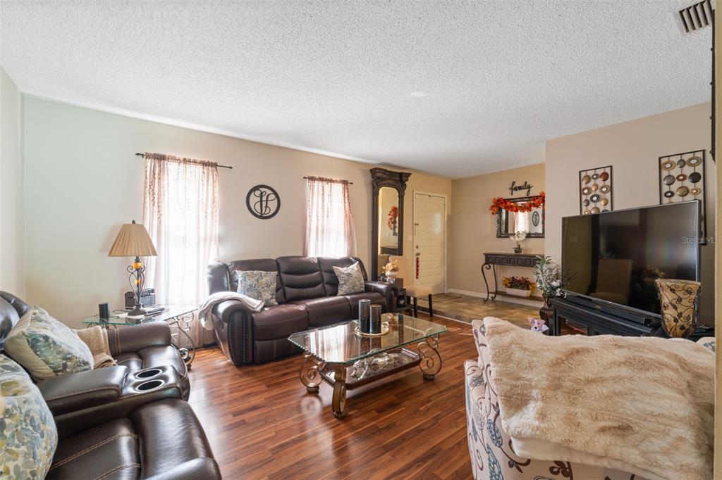12265 Shafton Road Spring Hill, FL 34608 - Photo 5 of 51 a living room with furniture and a flat screen tv