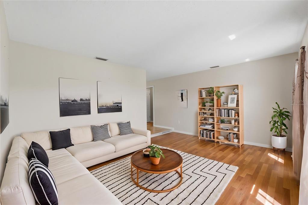 12265 Shafton Road Spring Hill, FL 34608 - Photo 6 of 58 a living room with furniture and a wooden floor