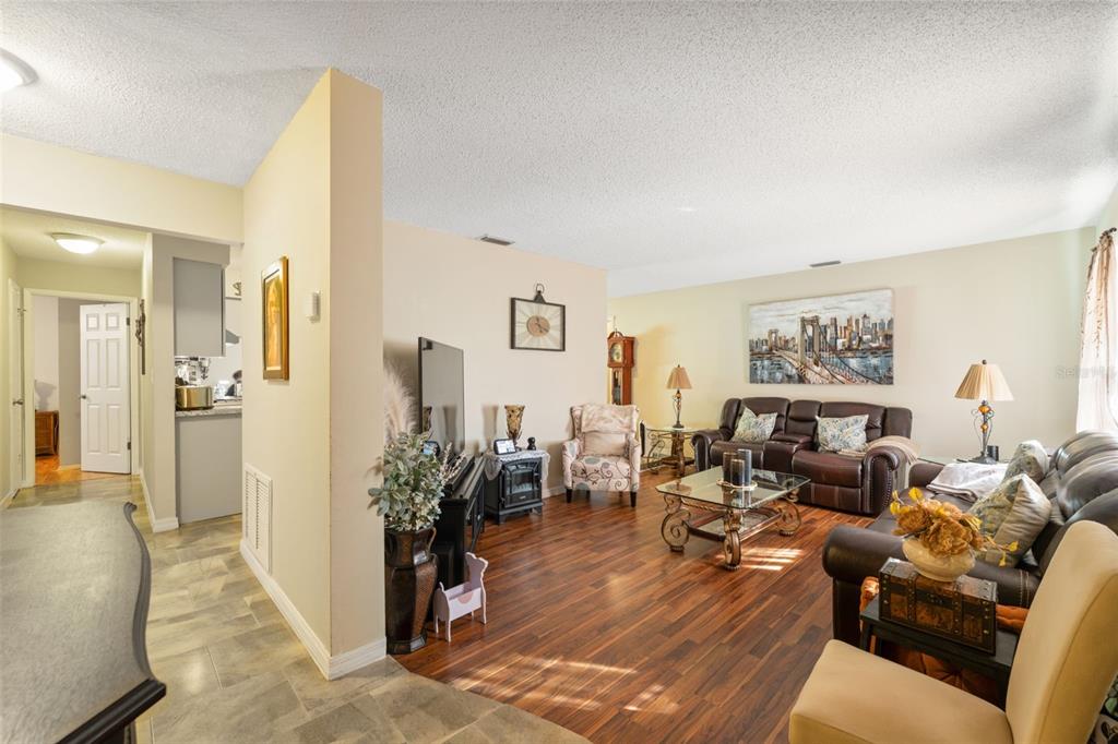 12265 Shafton Road Spring Hill, FL 34608 - Photo 6 of 51 a living room with furniture and a wooden floor