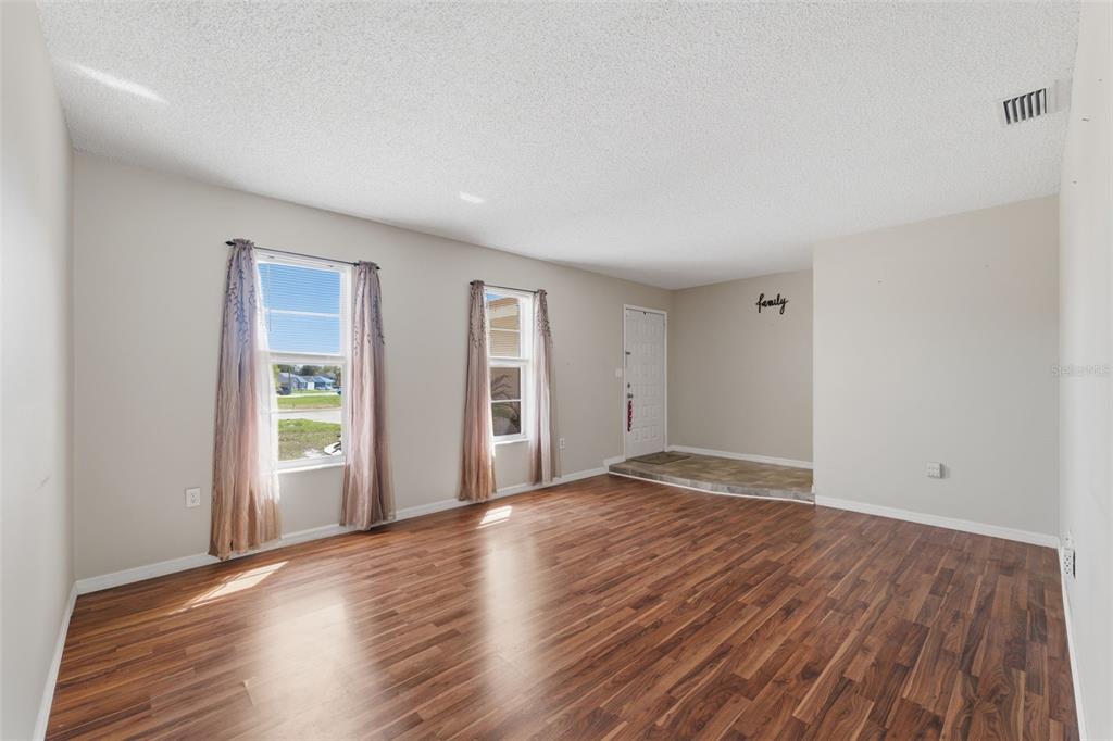 12265 Shafton Road Spring Hill, FL 34608 - Photo 7 of 58 a view of an empty room with wooden floor and a window