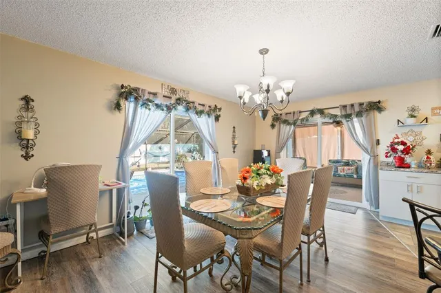 a spacious bedroom with a bed and a chandelier
