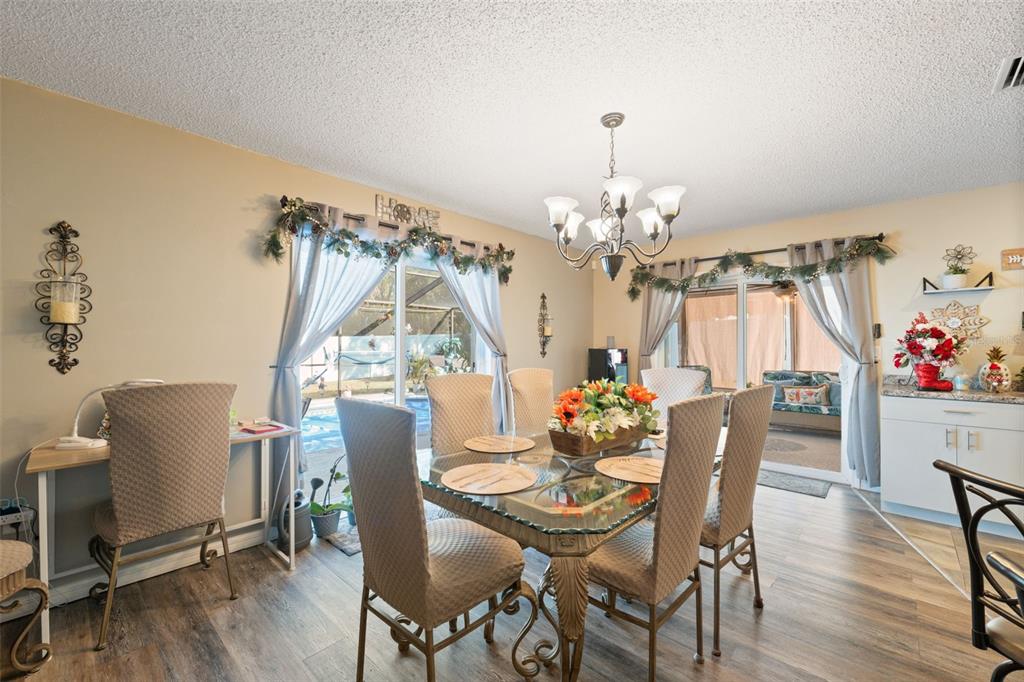 12265 Shafton Road Spring Hill, FL 34608 - Photo 10 of 51 a view of a dining room with furniture window and wooden floor