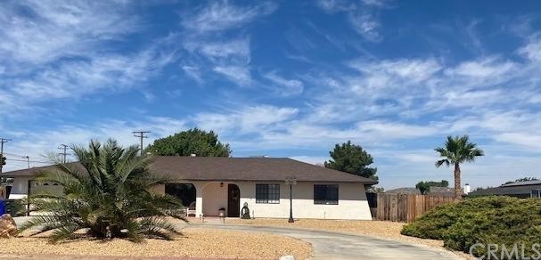 14186 Crow Road Apple Valley, CA 92307 - Photo 1 of 1 a front view of a house with garden