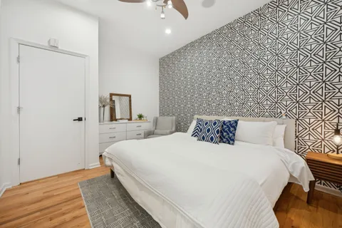 a large bed sitting in a bedroom next to a cabinet