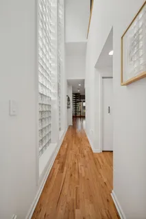 a view of a hallway with wooden floor and staircase