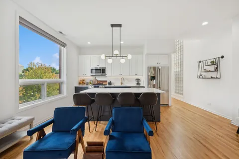 a view of kitchen with cabinets and wooden floor
