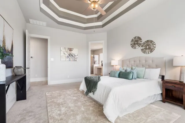 a bedroom with a bed and a chandelier