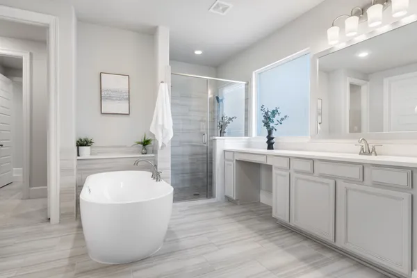 a spacious bathroom with a double vanity sink a mirror a bathtub and