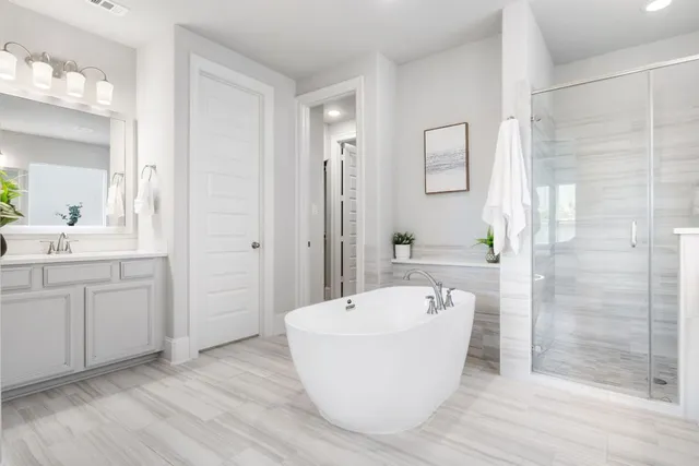 a spacious bathroom with a bathtub and a sink