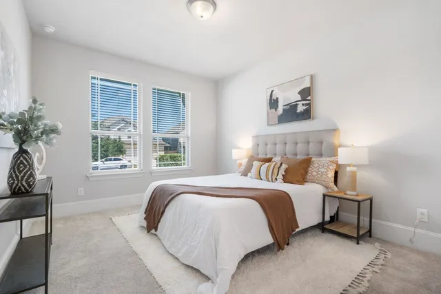 a bedroom with a large bed and a window