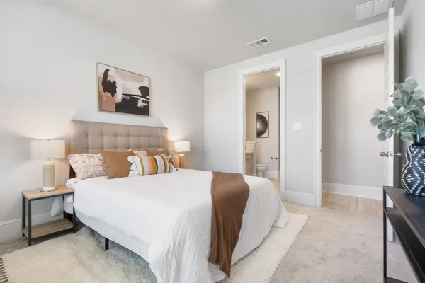 a bedroom with a bed and a potted plant