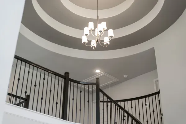 a view of a chandelier in a hall with wooden floor