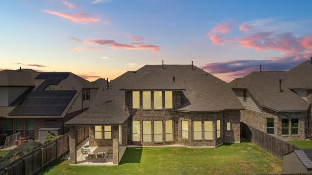 an aerial view of a house with outdoor space
