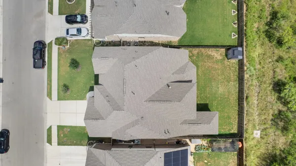an aerial view of houses with outdoor space and ocean view