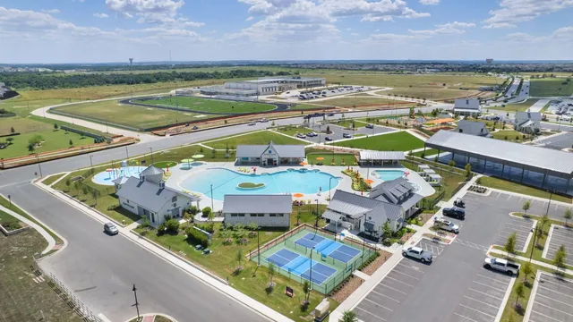 an aerial view of residential houses with outdoor space
