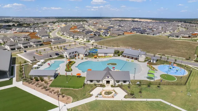 an aerial view of a houses with a swimming pool
