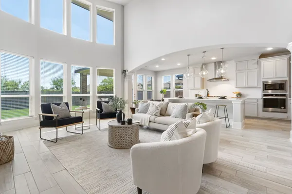 a living room with fireplace furniture and a large window
