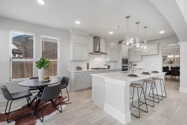 a view of a dining room with furniture and a chandelier