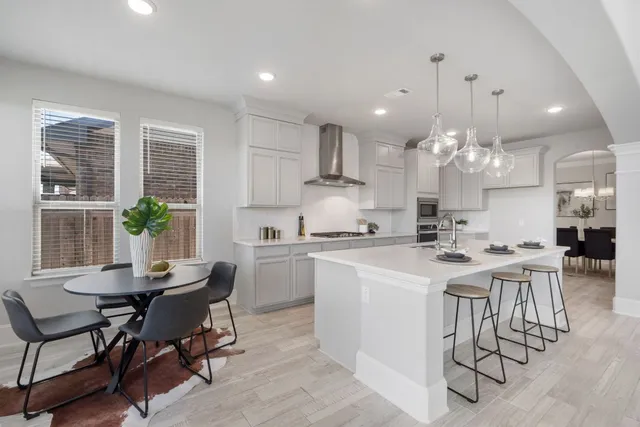 a view of a dining room with furniture and a chandelier