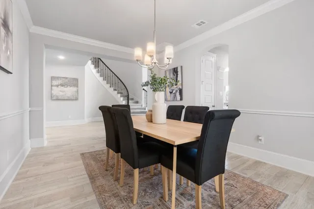 a view of a dining room with furniture and a chandelier