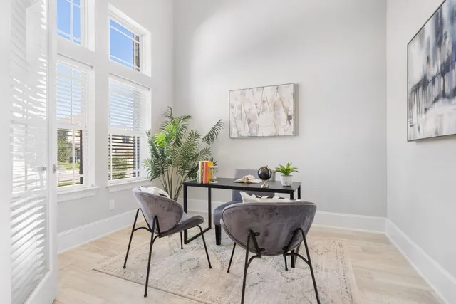 a dining room with furniture and window
