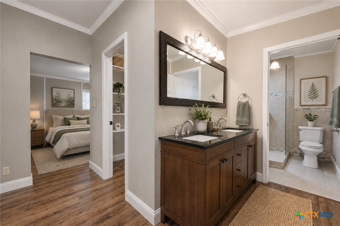 102 Rivercrest Street Luling, TX 78648 - Photo 8 of 36 a en suite bathroom with a granite countertop sink and a mirror