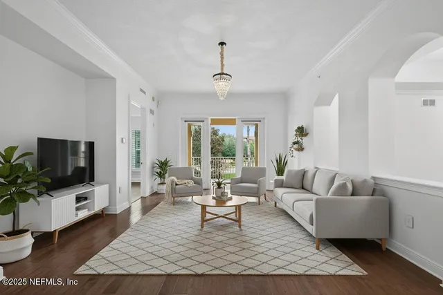 a living room with furniture a flat screen tv and a large window