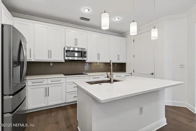 a kitchen with a sink and cabinets