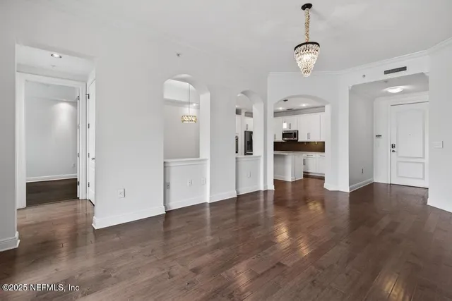 a kitchen with kitchen island a sink stainless steel appliances and cabinets