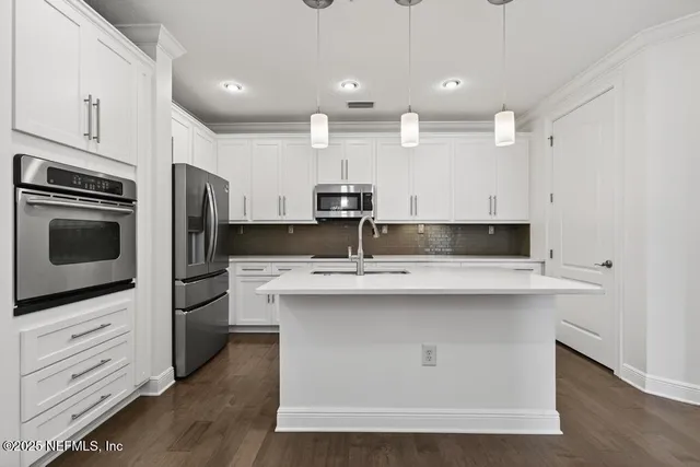 a kitchen with a sink a stove and refrigerator