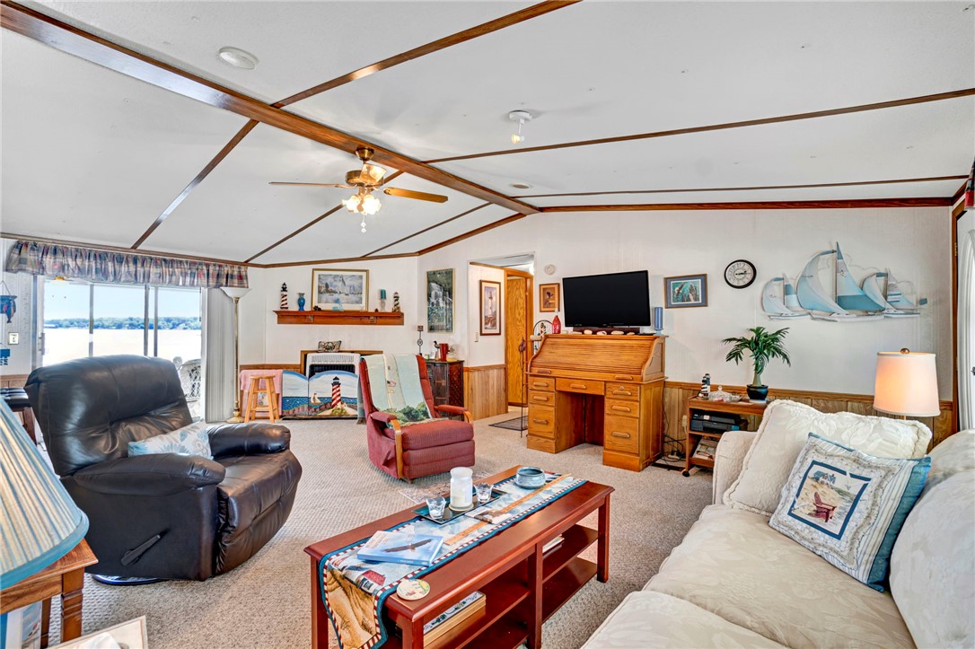 225 Nicholson Cove Road Seneca, SC 29672 - Photo 11 of 22 A comfortable living space offering serene lake views through broad sliding doors.
