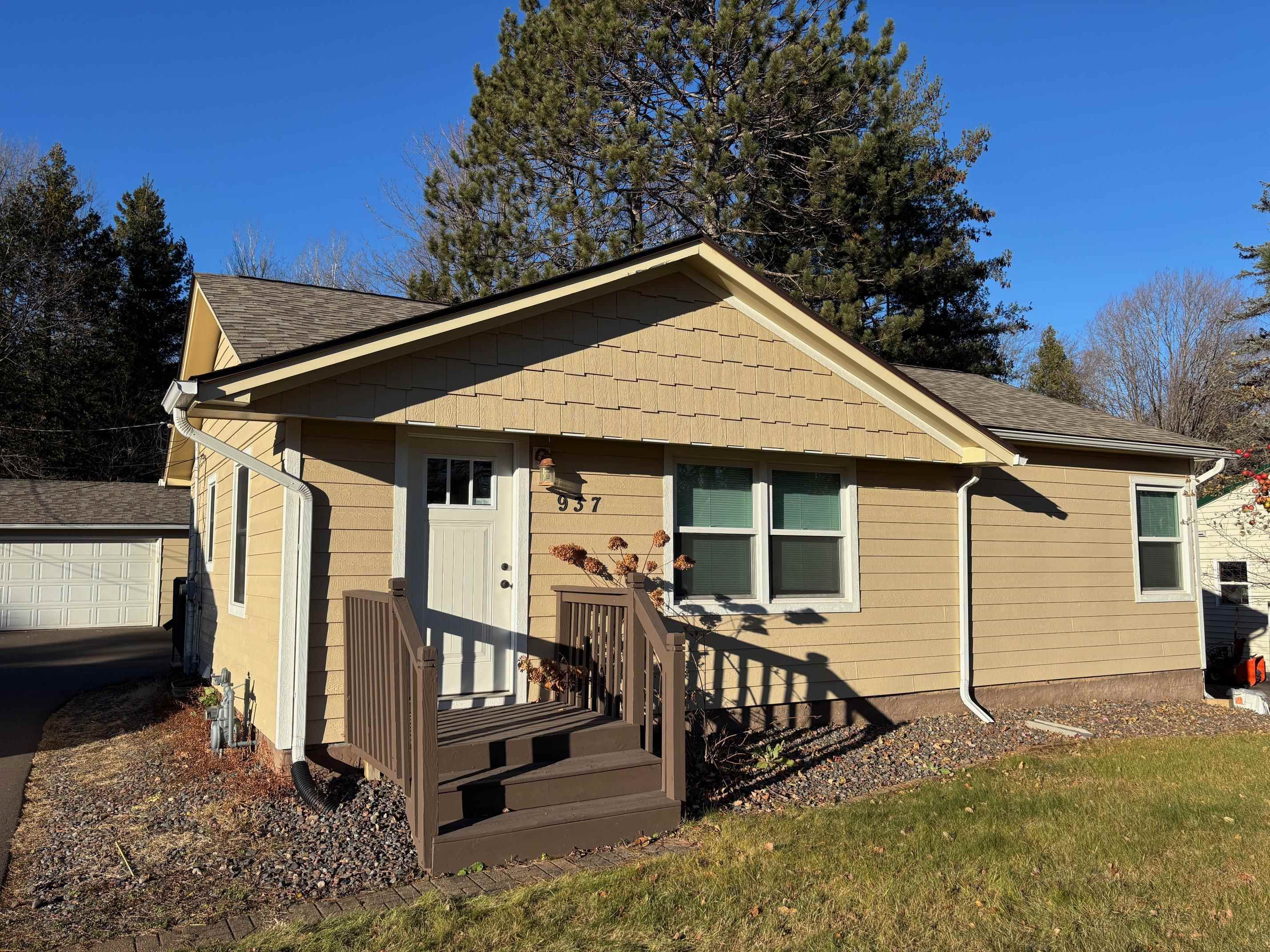 937 West Arrowhead Road Duluth, MN 55811 - Photo 19 of 23 Bungalow with a shingled roof, a garage, and a front lawn