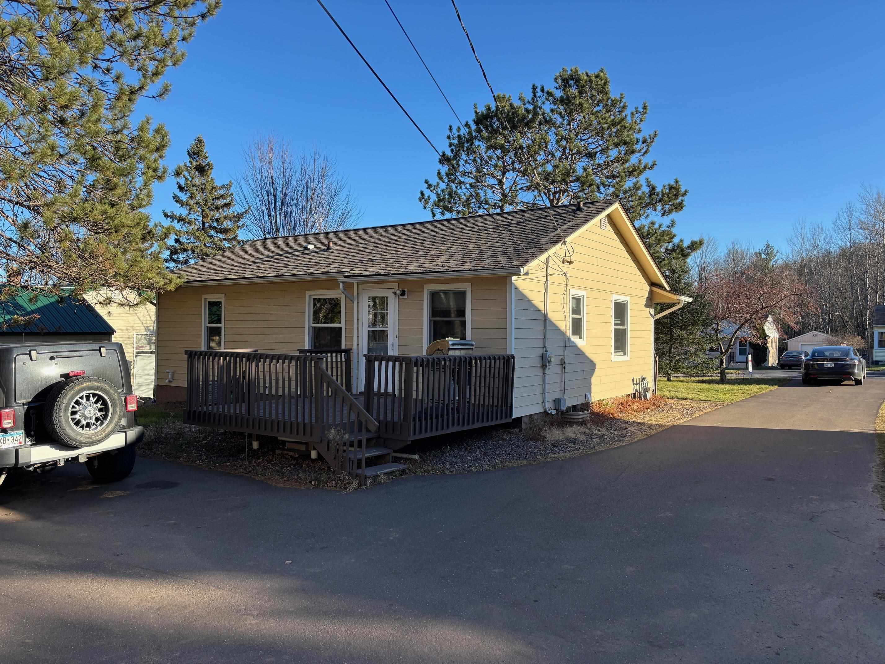 937 West Arrowhead Road Duluth, MN 55811 - Photo 22 of 23 View of front of home featuring a deck and a shingled roof