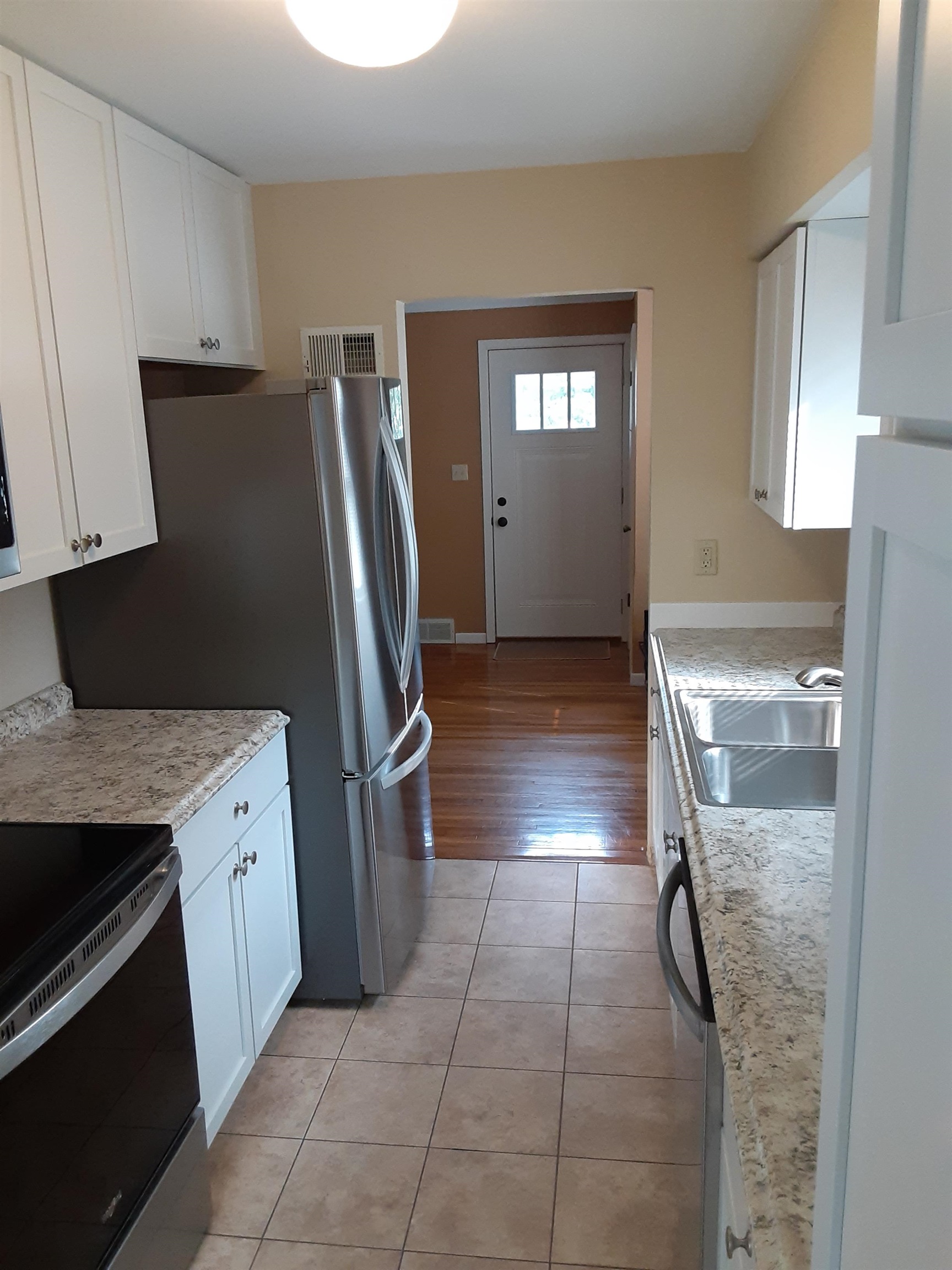 937 West Arrowhead Road Duluth, MN 55811 - Photo 7 of 23 Kitchen featuring appliances with stainless steel finishes, white cabinets, and light tile patterned floors.
