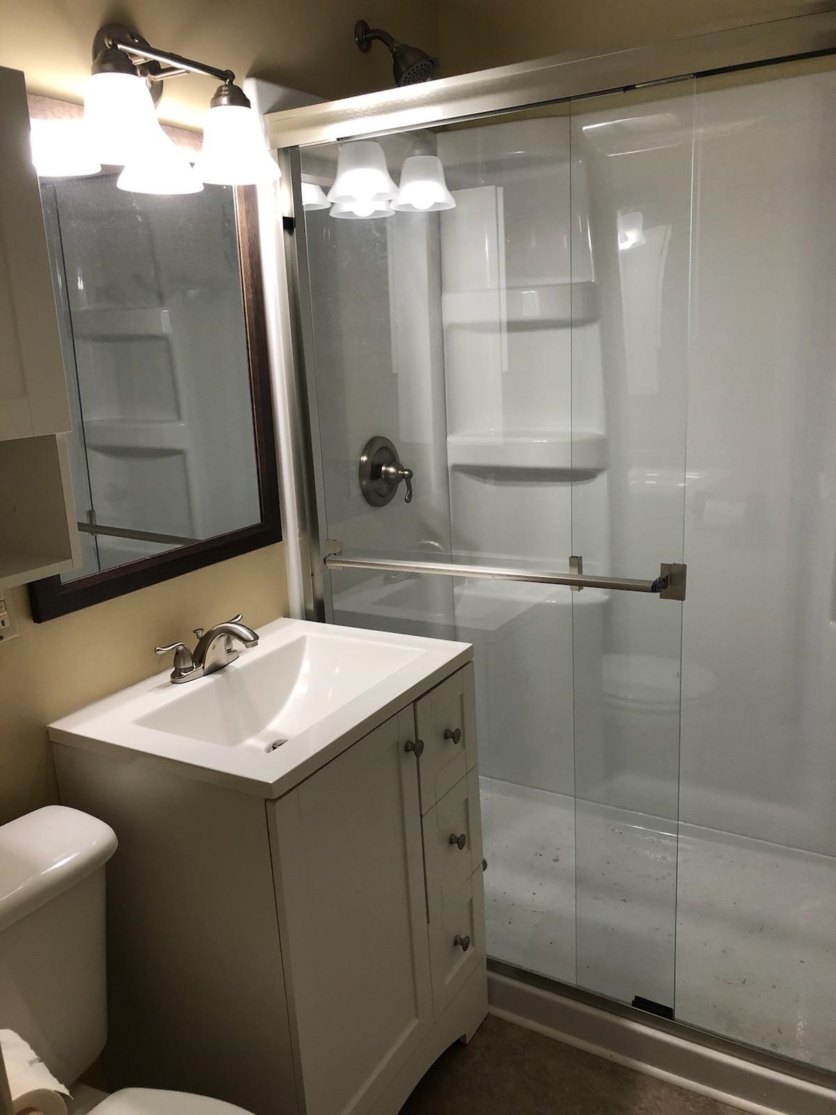 937 West Arrowhead Road Duluth, MN 55811 - Photo 10 of 23 Bathroom featuring vanity and a stall shower.