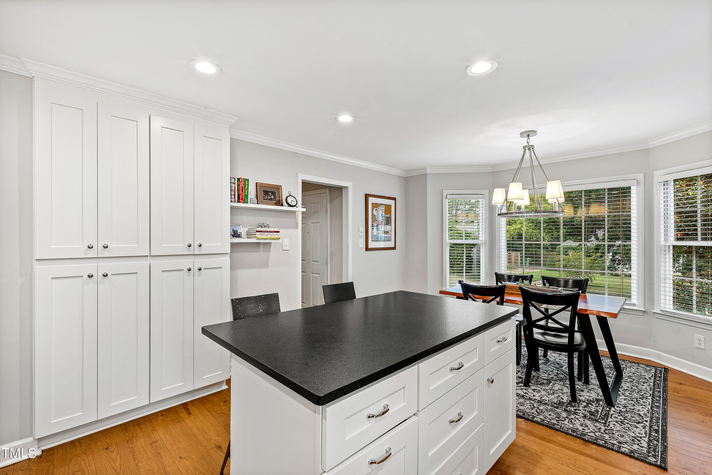 1816 Ridley Street Raleigh, NC 27608 - Photo 18 of 40 a kitchen with granite countertop a table chairs stove and refrigerator