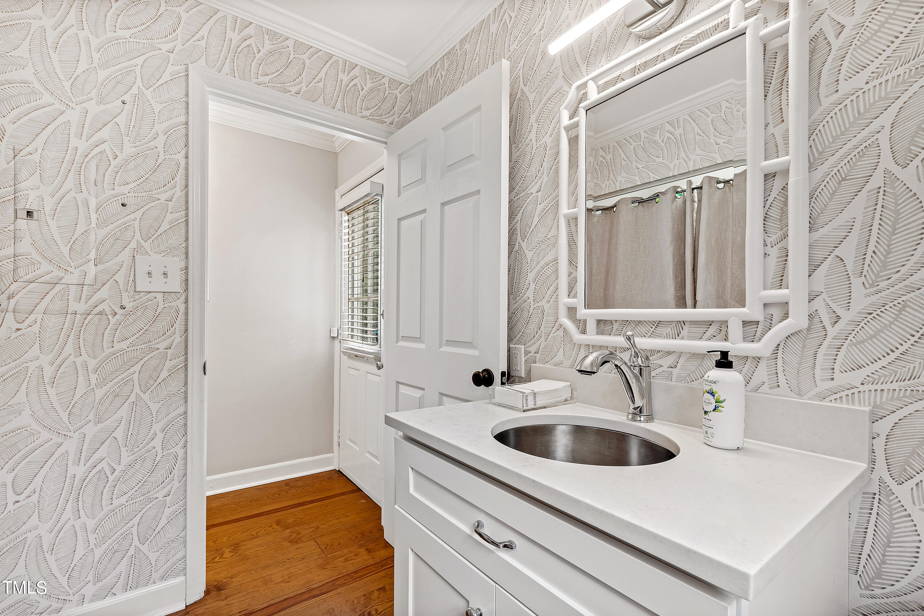 1816 Ridley Street Raleigh, NC 27608 - Photo 23 of 40 a bathroom with a sink and a mirror