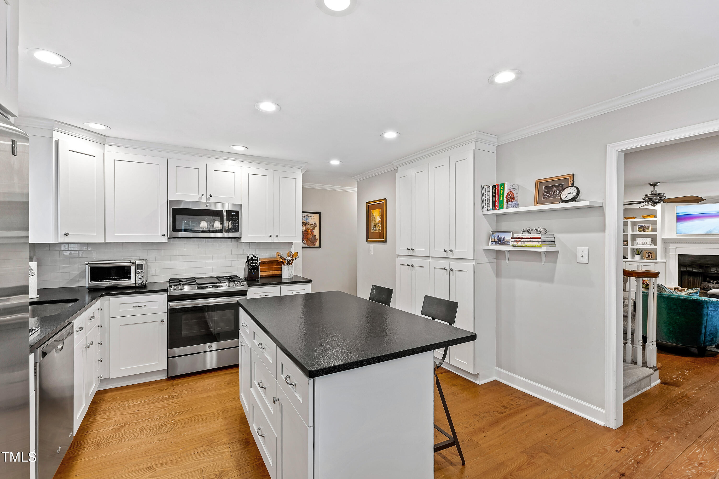 1816 Ridley Street Raleigh, NC 27608 - Photo 3 of 40 a kitchen with stainless steel appliances granite countertop a refrigerator stove microwave and sink