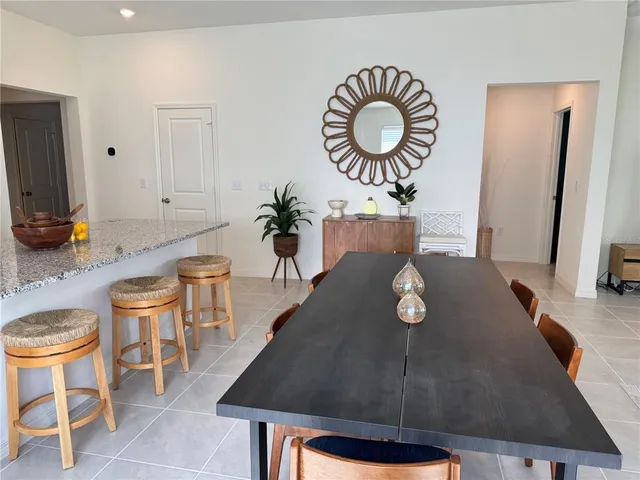 a living room with dining table and chairs