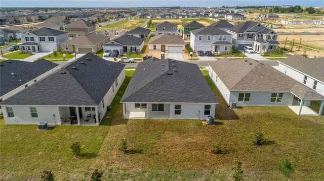 an aerial view of residential houses with swimming pool