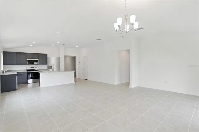 a view of a kitchen with a sink cabinets and stainless steel appliances