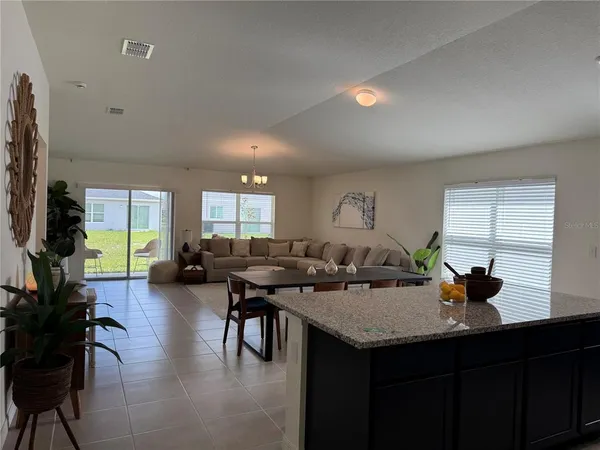 a open kitchen with a table and chairs in it