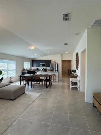 a living room with furniture and kitchen