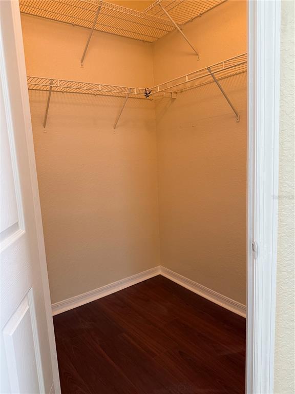 3725 Conroy Road, Unit 2127 Orlando, FL 32839 - Photo 24 of 30 an empty room with wooden floor and cabinet