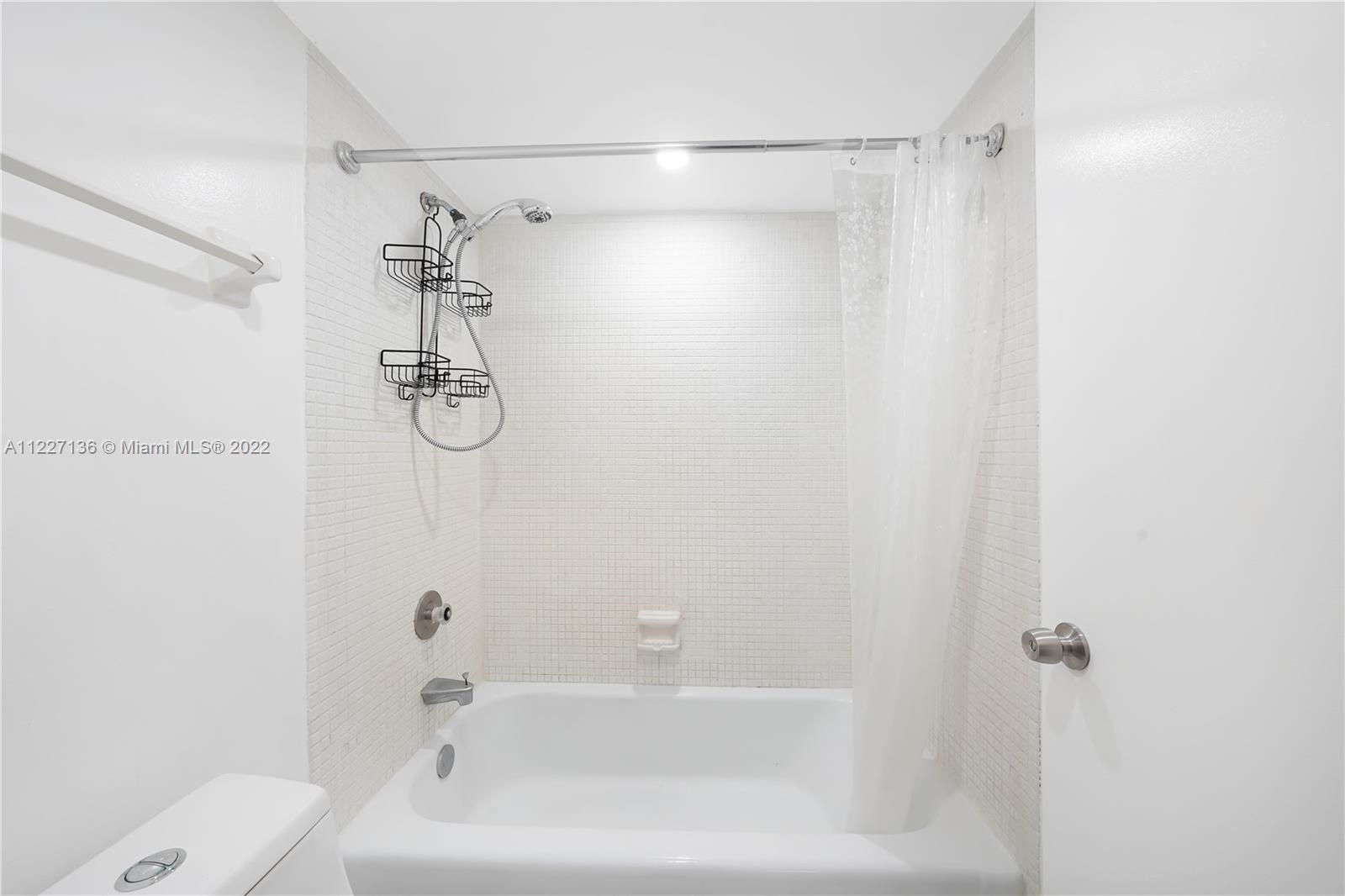 3670 Inverrary Drive, Unit 1I Lauderhill, FL 33319 - Photo 12 of 14 a bathroom with a bathtub and a shower