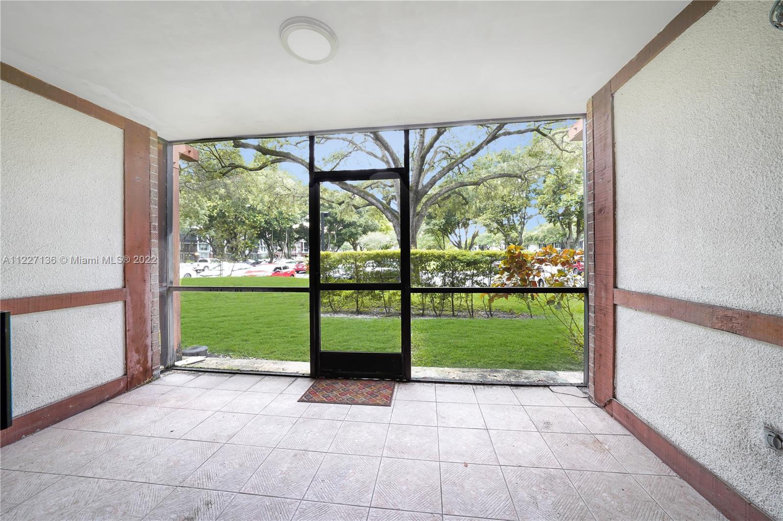3670 Inverrary Drive, Unit 1I Lauderhill, FL 33319 - Photo 14 of 14 a view of a room with a large window and an outdoor view