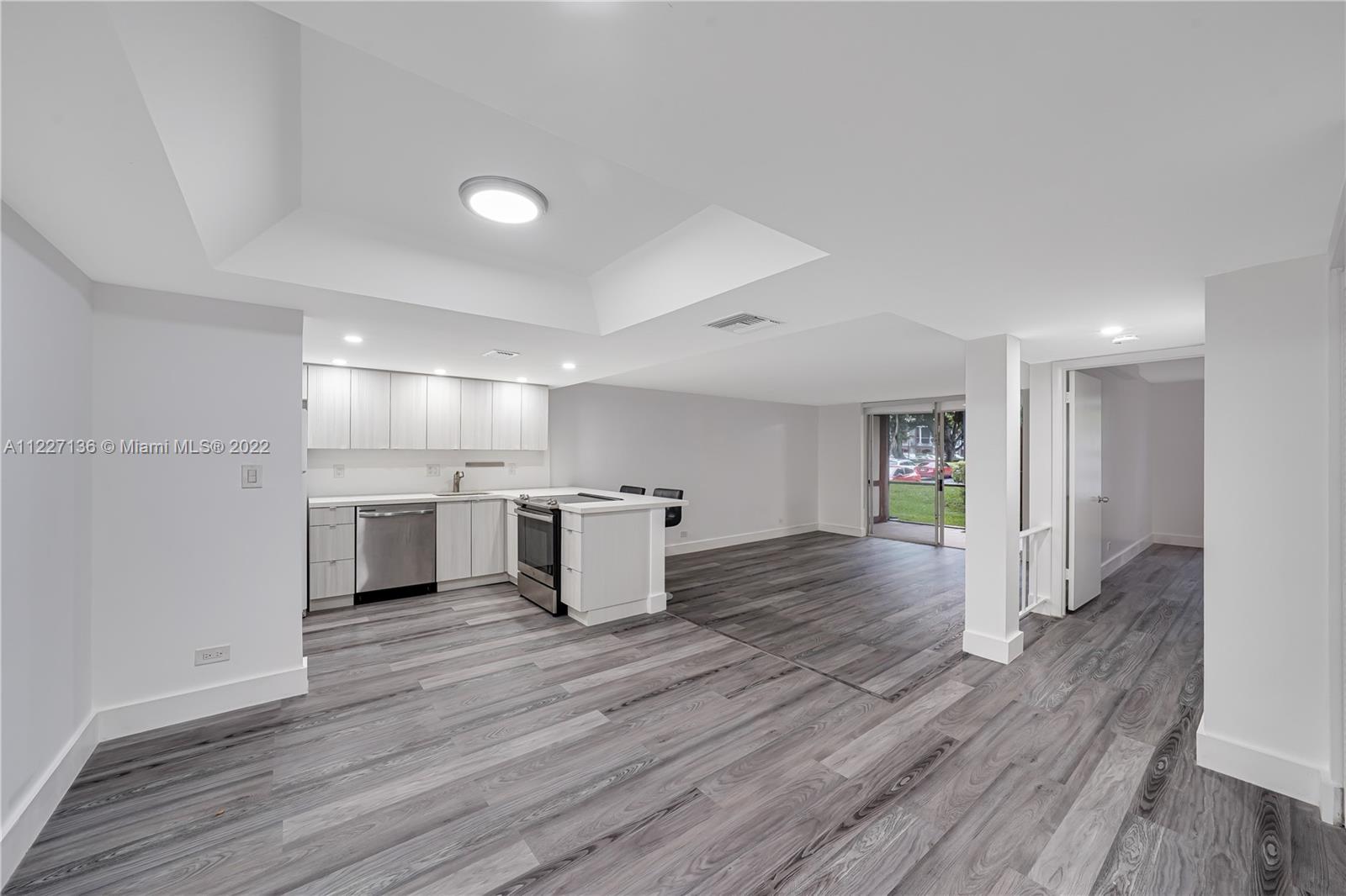 3670 Inverrary Drive, Unit 1I Lauderhill, FL 33319 - Photo 6 of 14 a view of a kitchen with a sink and wooden floor
