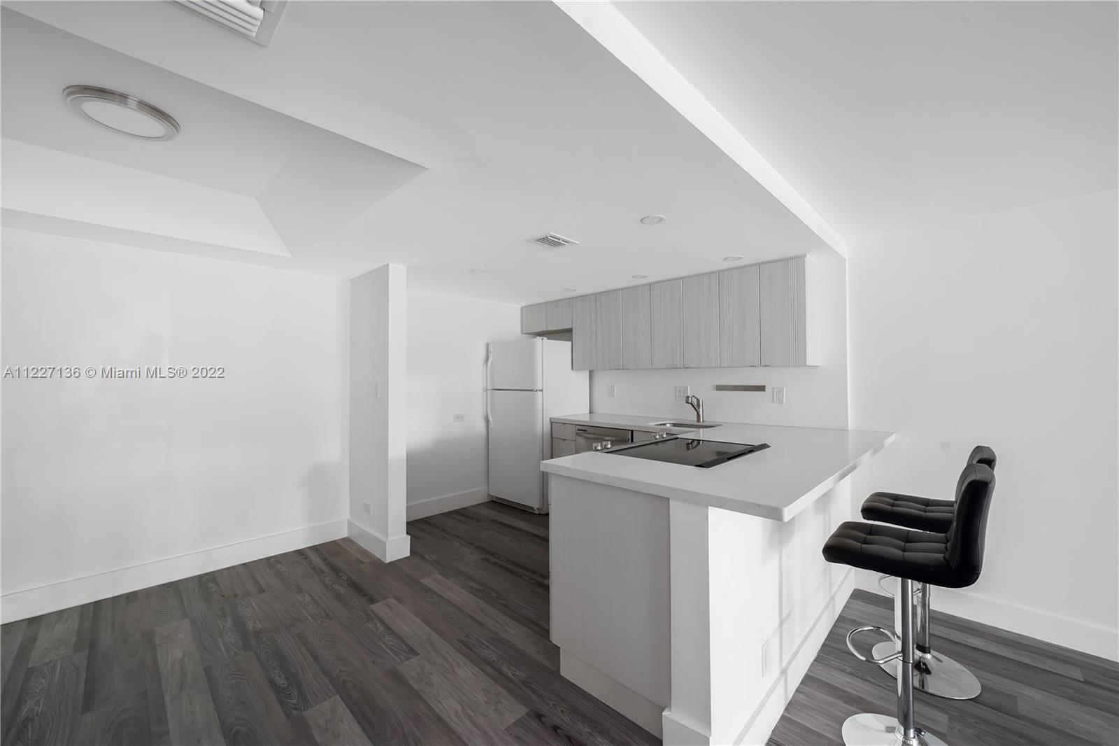 3670 Inverrary Drive, Unit 1I Lauderhill, FL 33319 - Photo 8 of 14 a kitchen with stainless steel appliances a stove and a refrigerator