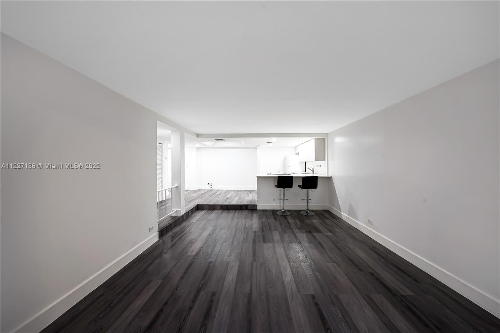 3670 Inverrary Drive, Unit 1I Lauderhill, FL 33319 - Photo 9 of 14 a view of empty room with wooden floor